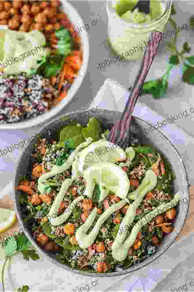 A Colorful Vegan Buddha Bowl Filled With Quinoa, Roasted Vegetables, Chickpeas, Avocado, And A Creamy Tahini Dressing Cooking By Plant Based Healthy: The 500 Plus Recipes Are Vegan Delicious