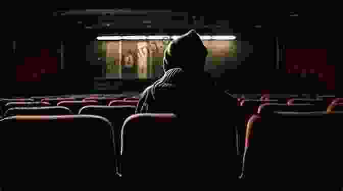 A Young Boy Sits In A Darkened Movie Theater, His Face Illuminated By The Flickering Light Of The Screen. The New Cinephilia Bill Bensley