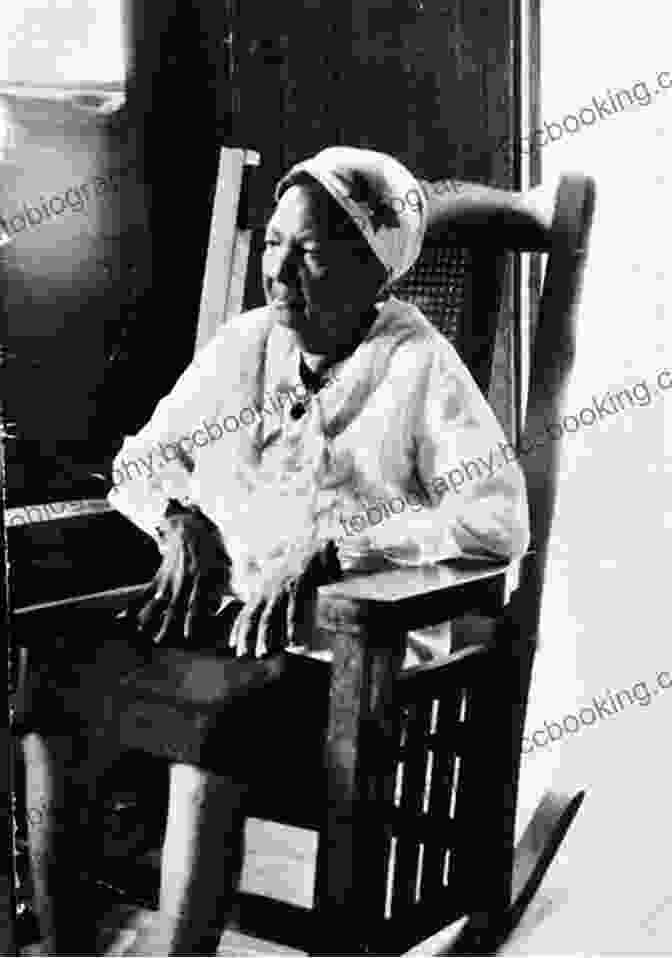 An Older African American Woman Sitting In A Rocking Chair, Surrounded By Quilts. Mama Bernice And The Coding Of The Quilt