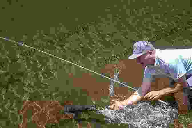 Image Of A Fisherman Handling A Fish IGFA S 101 Freshwater Fishing Tips Tricks